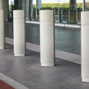 Row of stainless steel bollards with aesthetic sleeves.